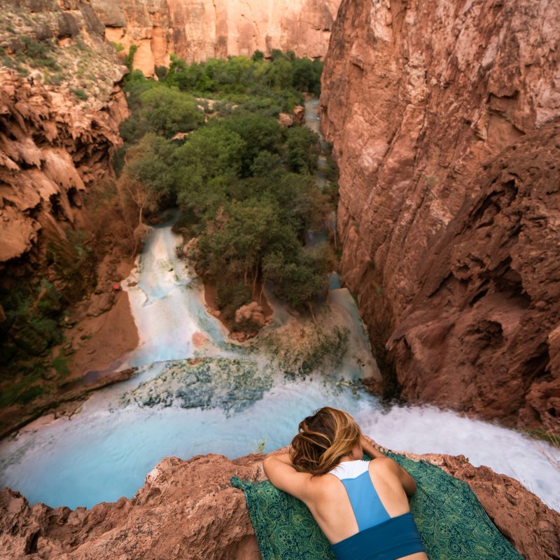 Blog post main photo of a woman relaxing in nature by a river.