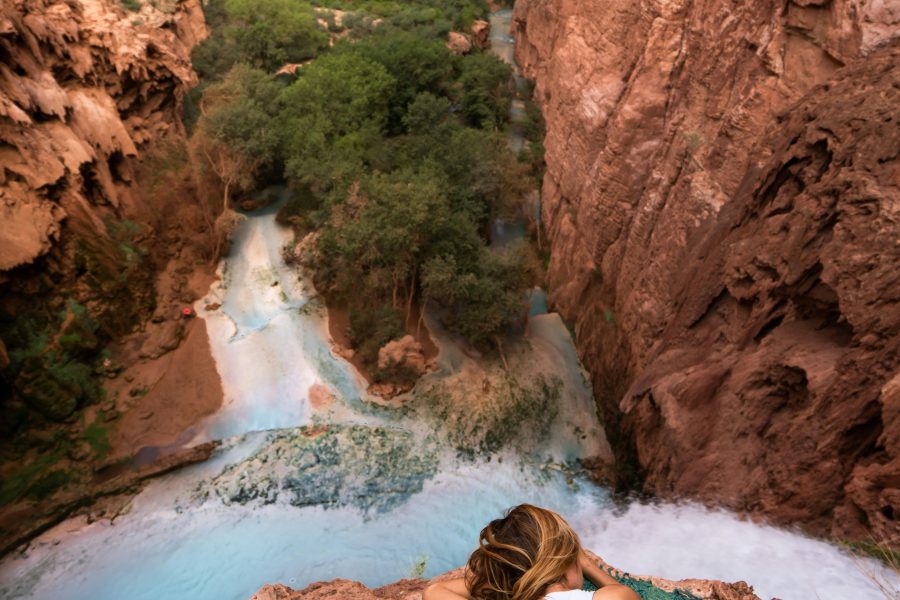 Blog post main photo of a woman relaxing in nature by a river.